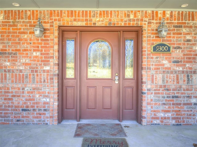 view of exterior entry with brick siding