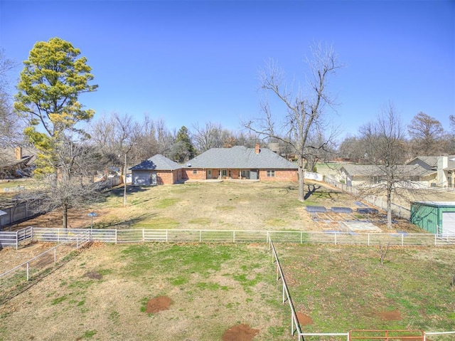 exterior space with a rural view, a front yard, and fence