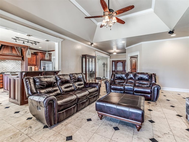 living room featuring a towering ceiling, baseboards, a ceiling fan, and ornamental molding