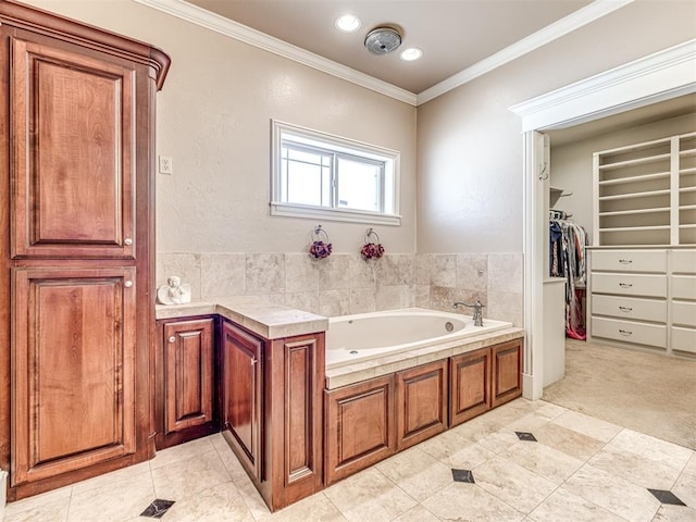 full bath featuring a walk in closet, a garden tub, recessed lighting, and ornamental molding