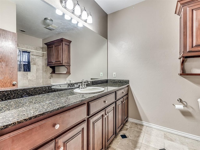 bathroom featuring curtained shower, vanity, and baseboards