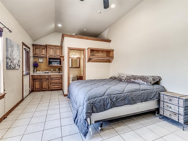 bedroom with connected bathroom, baseboards, vaulted ceiling, light tile patterned floors, and recessed lighting