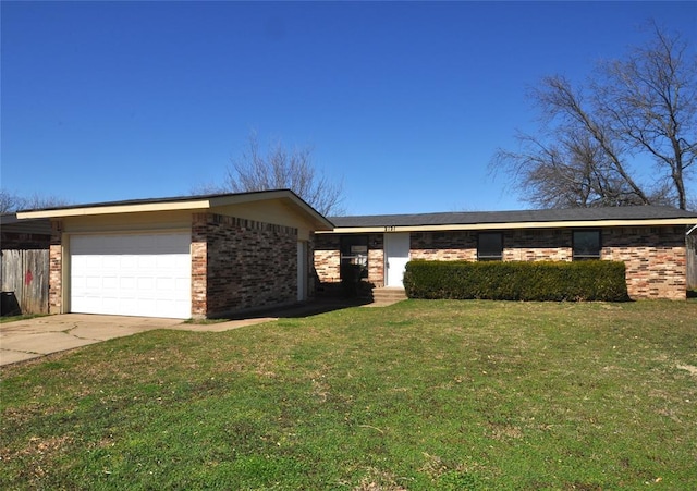 view of front of home featuring a front yard, an attached garage, brick siding, and concrete driveway