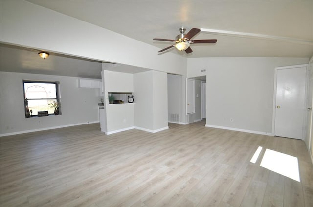 2121 Memphis Dr, Norman, OK 73071 - unfurnished living room featuring a ceiling fan, baseboards, visible vents, vaulted ceiling, and light wood-type flooring