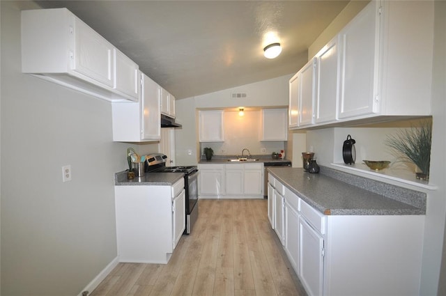2121 Memphis Dr, Norman, OK 73071 - kitchen with under cabinet range hood, a sink, stainless steel range with electric cooktop, white cabinets, and vaulted ceiling