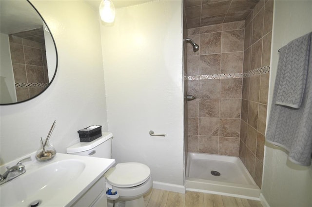 2121 Memphis Dr, Norman, OK 73071 - bathroom featuring vanity, wood finished floors, baseboards, a stall shower, and toilet
