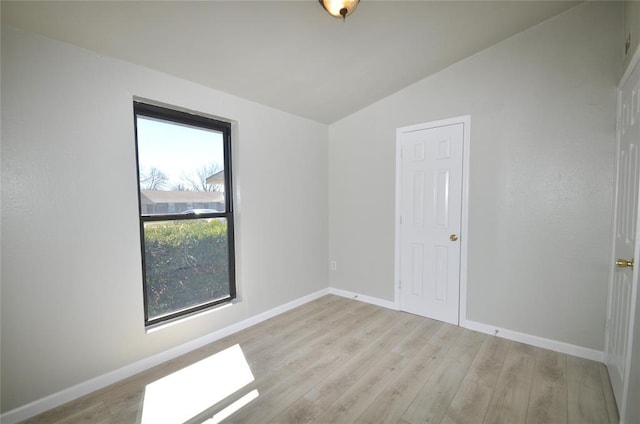 2121 Memphis Dr, Norman, OK 73071 - empty room with baseboards, lofted ceiling, and wood finished floors