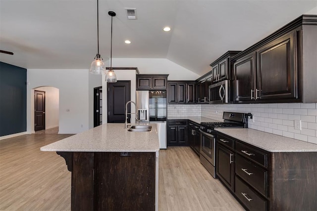 kitchen featuring visible vents, light wood-style flooring, appliances with stainless steel finishes, and a sink