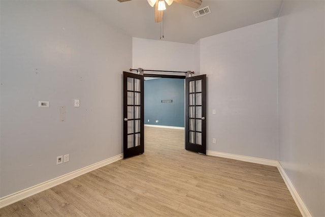 unfurnished room with visible vents, wood finished floors, french doors, baseboards, and ceiling fan