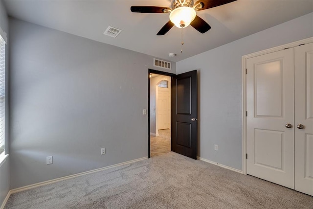 unfurnished bedroom with visible vents, ceiling fan, baseboards, and carpet floors