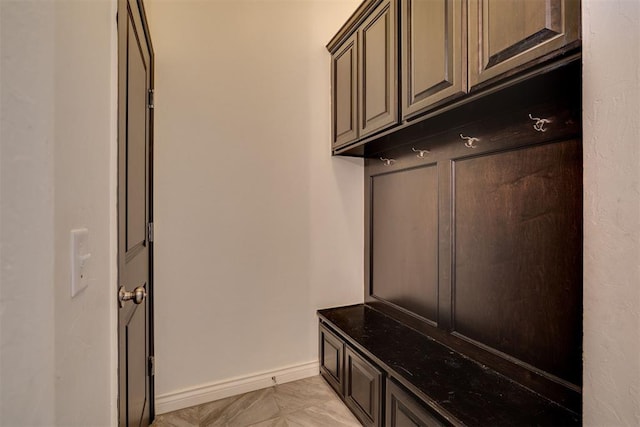 mudroom featuring baseboards and marble finish floor