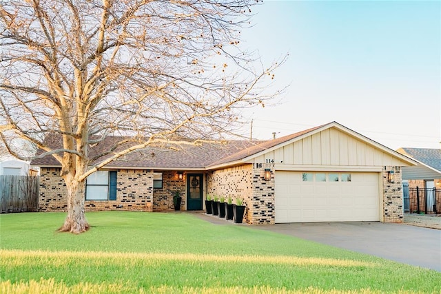 ranch-style home with a garage, brick siding, a front lawn, and fence