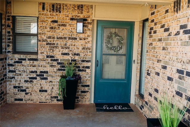 property entrance featuring brick siding