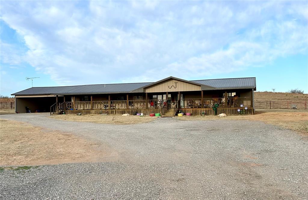 10371 N 1820, Cheyenne, OK 73628 - view of front of home with an outbuilding, an exterior structure, driveway, and metal roof