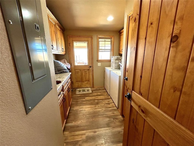 washroom with cabinet space, separate washer and dryer, and wood finished floors