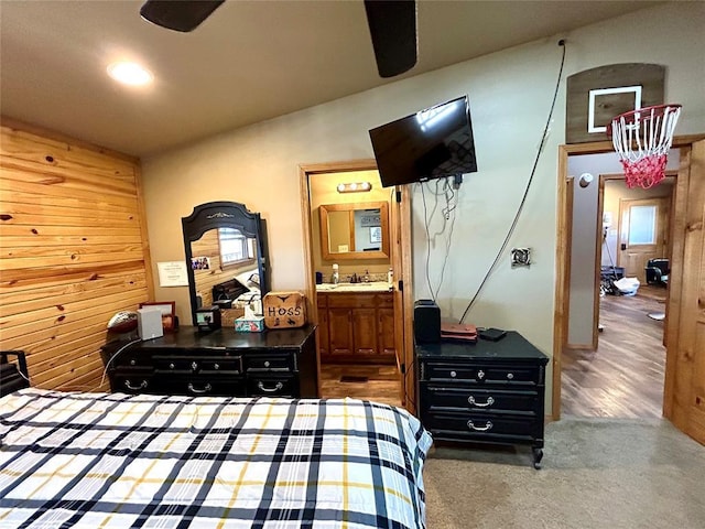 bedroom featuring wood finished floors and ensuite bath