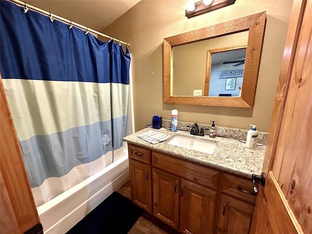 bathroom featuring shower / bath combo and vanity