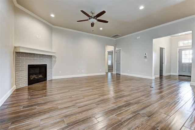 unfurnished living room featuring wood finished floors, a ceiling fan, visible vents, and baseboards