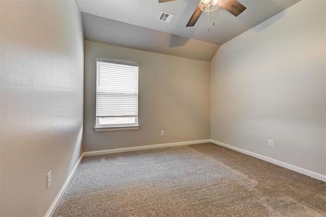 carpeted empty room featuring visible vents, lofted ceiling, baseboards, and a ceiling fan