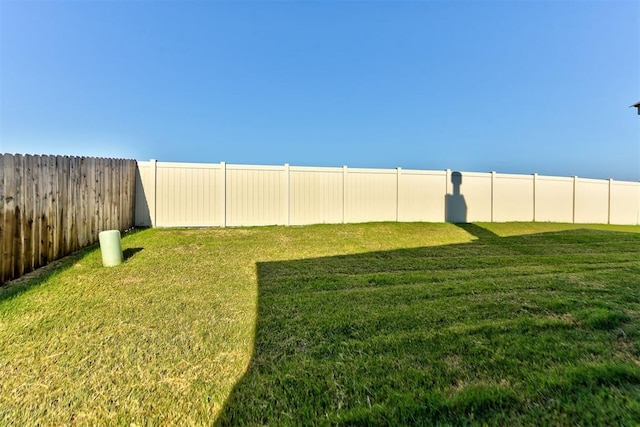 view of yard with a fenced backyard