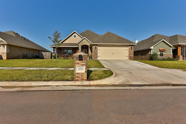 craftsman-style home featuring concrete driveway, a front yard, a garage, brick siding, and central AC unit