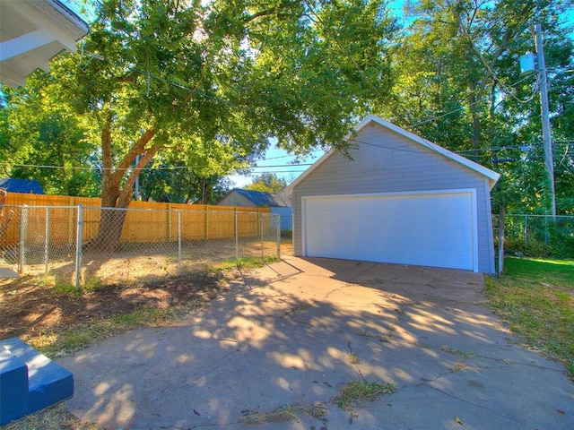 detached garage featuring fence