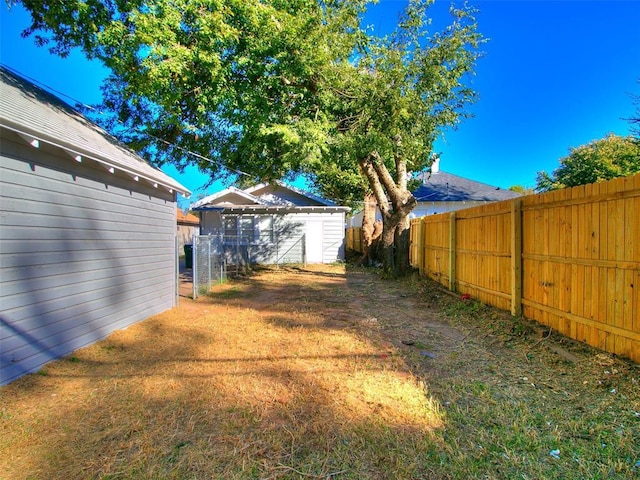 view of yard with an outbuilding and a fenced backyard