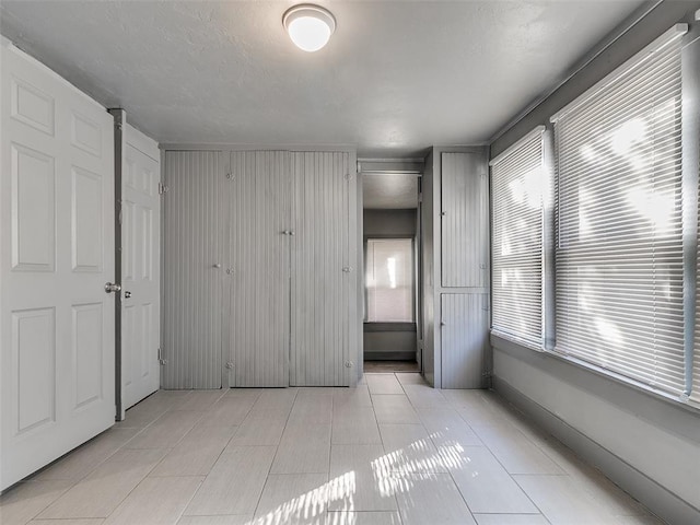 unfurnished bedroom featuring light tile patterned flooring