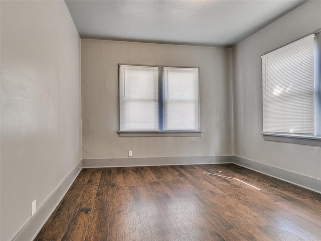 unfurnished room with wood finished floors and baseboards