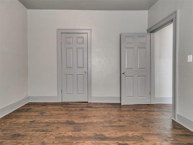 spare room featuring wood finished floors and baseboards