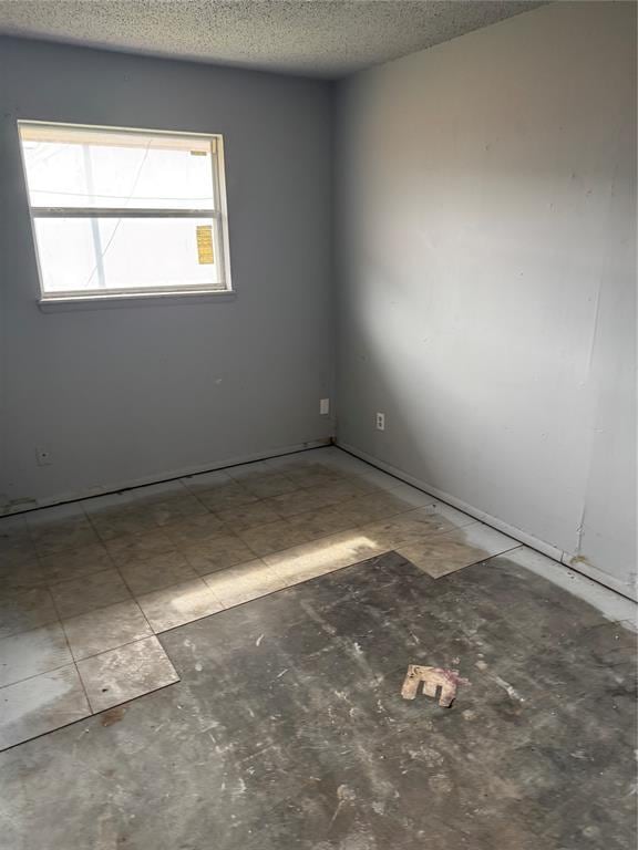 empty room with a textured ceiling