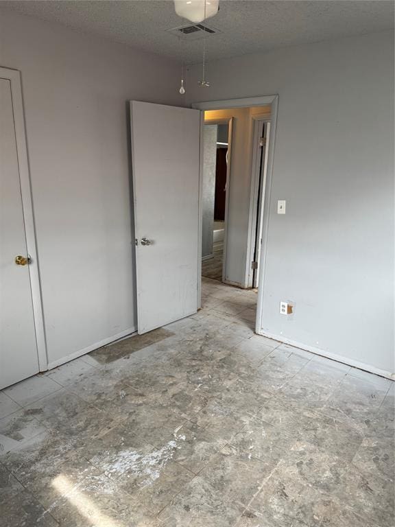 empty room featuring visible vents and a textured ceiling