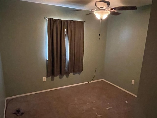 spare room with baseboards and ceiling fan