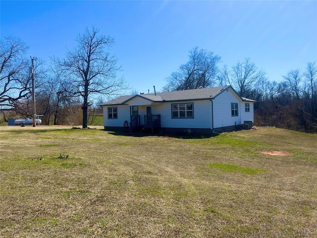 view of front of house featuring cooling unit and a front yard