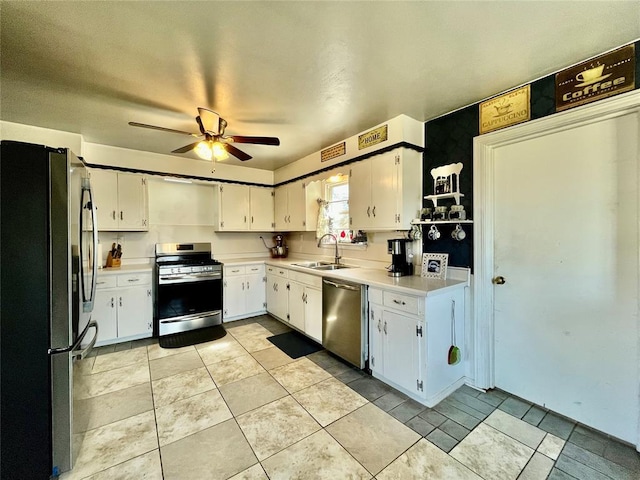 kitchen with light countertops, white cabinets, appliances with stainless steel finishes, and a sink