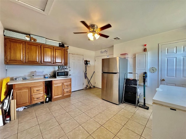 kitchen featuring light countertops, light tile patterned floors, visible vents, and appliances with stainless steel finishes