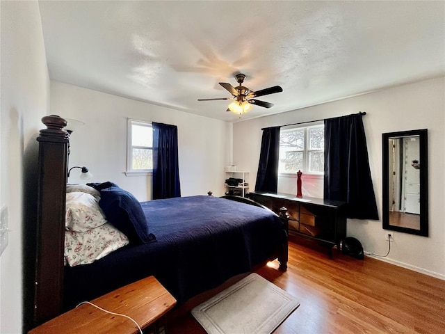 bedroom with a ceiling fan and wood finished floors