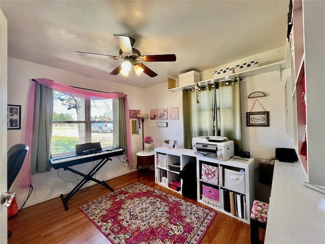 office space with wood finished floors and ceiling fan