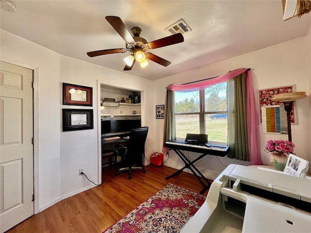 office area featuring visible vents, ceiling fan, baseboards, and light wood-style floors