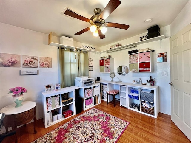 recreation room with ceiling fan and wood finished floors