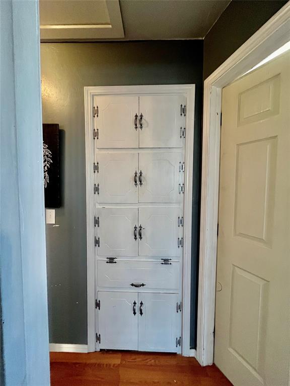 entryway with wood finished floors and baseboards