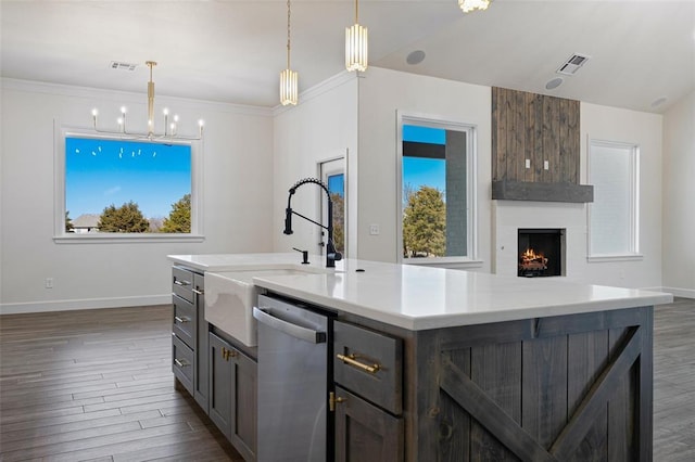 kitchen with a sink, visible vents, dishwasher, and dark wood-style flooring