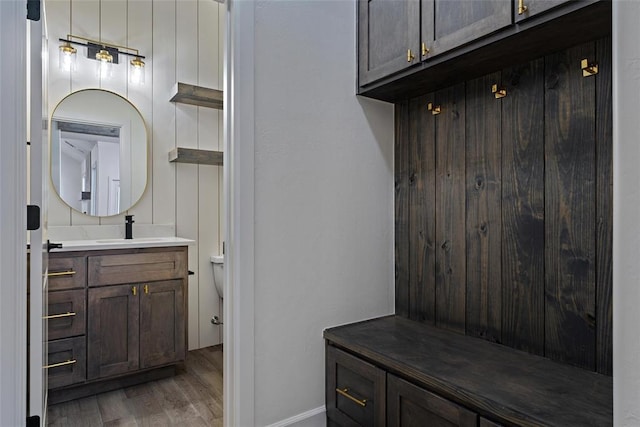 mudroom with a sink and light wood finished floors