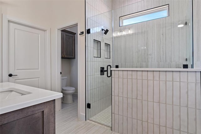 full bath with a shower stall, toilet, and vanity