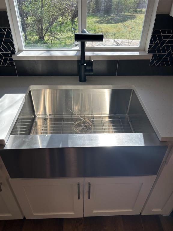 details featuring white cabinetry, light countertops, and a sink