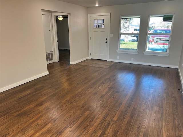 entrance foyer featuring visible vents, baseboards, and dark wood finished floors