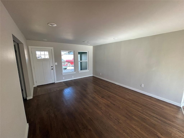 interior space featuring dark wood-style floors and baseboards