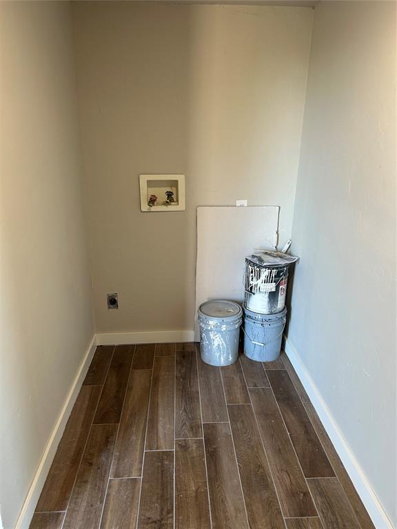 washroom with laundry area, wood finished floors, baseboards, and electric dryer hookup