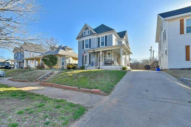 view of front of house with a front lawn, covered porch, and a residential view