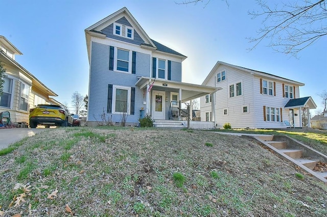 american foursquare style home featuring a porch